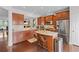 Open kitchen featuring an island, stainless steel appliances, granite counters and dark wood cabinetry at 2428 Hadlow Ln # 25, Atlanta, GA 30339
