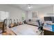 Multi-purpose room with guitars, desk area, and a comfortable gray couch at 2428 Hadlow Ln # 25, Atlanta, GA 30339