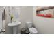 Powder room featuring a pedestal sink, toilet, and decorative wall art at 2428 Hadlow Ln # 25, Atlanta, GA 30339
