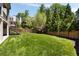 Expansive backyard featuring lush green grass, a wooden fence, and mature trees surrounding the property at 2609 Dogwood Terrace Ne, Atlanta, GA 30319