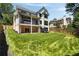 Exterior view of a home highlighting the backyard, deck, and patio, all surrounded by a lush lawn at 2609 Dogwood Terrace Ne, Atlanta, GA 30319