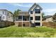 Back exterior view of home with a spacious yard, deck, and lower level patio at 2609 Dogwood Terrace Ne, Atlanta, GA 30319