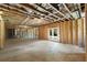 Unfinished basement featuring exposed wood and ductwork, with walkout to the backyard at 2609 Dogwood Terrace Ne, Atlanta, GA 30319