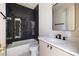 Stylish bathroom with modern fixtures, a vanity with countertop, and a bathtub with a dark tiled wall at 2609 Dogwood Terrace Ne, Atlanta, GA 30319