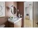 Elegant powder room with marble countertop, decorative mirror, designer lighting, and a stylish sink at 2609 Dogwood Terrace Ne, Atlanta, GA 30319