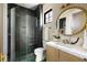 Modern bathroom with sleek glass shower, stylish vanity, and chic gold mirror at 2609 Dogwood Terrace Ne, Atlanta, GA 30319