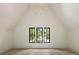 Bright bedroom with vaulted ceilings, hardwood floors, three windows, and a modern chandelier at 2609 Dogwood Terrace Ne, Atlanta, GA 30319