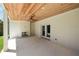 Covered patio area with brick flooring, a painted brick fireplace, ceiling fan, and access to the backyard at 2609 Dogwood Terrace Ne, Atlanta, GA 30319