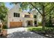 Elegant two-story home featuring a brick facade, wooden garage doors, manicured lawn, and inviting curb appeal at 2609 Dogwood Terrace Ne, Atlanta, GA 30319