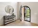 Bright foyer with stylish console table, decorative mirror, and open view through arched front door to the exterior at 2609 Dogwood Terrace Ne, Atlanta, GA 30319