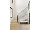 Modern staircase with white risers, black metal railing, and cozy bench seating area underneath at 2609 Dogwood Terrace Ne, Atlanta, GA 30319