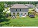 Large backyard featuring patio, trampoline, playground, fire pit, and lush green lawn at 3420 Pleasant Springs Dr, Cumming, GA 30028
