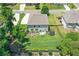 Aerial view of a fully fenced backyard, boasting a lush lawn, patio seating, and a trampoline at 3420 Pleasant Springs Dr, Cumming, GA 30028