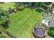 Expansive backyard with mature landscaping, trampoline, patio area and fire pit at 3420 Pleasant Springs Dr, Cumming, GA 30028