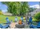 Cozy stone patio area with a fire pit and comfortable seating in a lush green backyard at 3420 Pleasant Springs Dr, Cumming, GA 30028