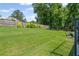 Lush green backyard with a privacy fence and a cozy seating area for outdoor relaxation at 3420 Pleasant Springs Dr, Cumming, GA 30028