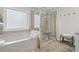Bathroom featuring separate bathtub and shower with neutral colored tile at 3420 Pleasant Springs Dr, Cumming, GA 30028