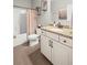 Bright bathroom features a granite countertop, white cabinets, and a combined tub and shower at 3420 Pleasant Springs Dr, Cumming, GA 30028