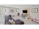 Spacious bonus room with media center, lounge seating and area at 3420 Pleasant Springs Dr, Cumming, GA 30028