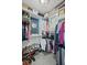 Organized walk-in closet with shelving, hanging rods and dedicated shoe racks at 3420 Pleasant Springs Dr, Cumming, GA 30028