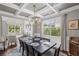 Elegant dining room with coffered ceiling, chandelier, and large windows at 3420 Pleasant Springs Dr, Cumming, GA 30028
