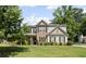Charming two-story home with stone accents, landscaped lawn, and mature trees at 3420 Pleasant Springs Dr, Cumming, GA 30028