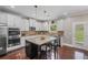 Updated kitchen featuring stainless steel appliances, granite counters, white cabinets, and dark wood flooring at 3420 Pleasant Springs Dr, Cumming, GA 30028