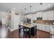 Modern kitchen with white cabinets, granite countertops, stainless steel appliances, and a central island at 3420 Pleasant Springs Dr, Cumming, GA 30028