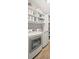 Well-organized laundry room with built in shelves and modern washer and dryer at 3420 Pleasant Springs Dr, Cumming, GA 30028