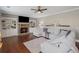 Inviting living room with a stone fireplace, custom bookshelves, and comfortable seating arrangement at 3420 Pleasant Springs Dr, Cumming, GA 30028