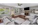 Cozy living room features a fireplace, built-in shelves, large windows, and hardwood flooring at 3420 Pleasant Springs Dr, Cumming, GA 30028