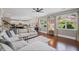 Bright living room with a sectional sofa, hardwood floors, and large windows for natural light at 3420 Pleasant Springs Dr, Cumming, GA 30028