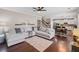 Open living space with a sofa, stairs, and a view into the modern kitchen with an island at 3420 Pleasant Springs Dr, Cumming, GA 30028