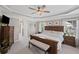 The spacious main bedroom features a tray ceiling, and a seating area at 3420 Pleasant Springs Dr, Cumming, GA 30028