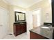 Bathroom showcasing a vanity with dark wood cabinets and black countertop, tile floor and white doors at 3541 Roswell Ne Rd # 20, Atlanta, GA 30305