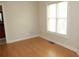 Sunlit bedroom showcasing pristine hardwood floors and a large window at 3541 Roswell Ne Rd # 20, Atlanta, GA 30305