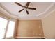 Bedroom with wood-look accent wall, ceiling fan, bay window, and neutral color scheme at 3541 Roswell Ne Rd # 20, Atlanta, GA 30305