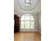 Bright dining room features a large arched window, contemporary light fixture and wood floors at 3541 Roswell Ne Rd # 20, Atlanta, GA 30305