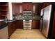 Well-appointed kitchen features stainless steel appliances, dark cabinets, and tile backsplash at 3541 Roswell Ne Rd # 20, Atlanta, GA 30305