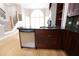 Open kitchen with island, dark cabinets, stainless steel appliances, and hardwood floors at 3541 Roswell Ne Rd # 20, Atlanta, GA 30305
