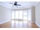 Bright living room featuring light hardwood floors, a ceiling fan, and large windows for natural light at 3541 Roswell Ne Rd # 20, Atlanta, GA 30305
