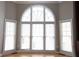 Bright living room with large arch window and hardwood floors at 3541 Roswell Ne Rd # 20, Atlanta, GA 30305
