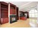 Open-concept living room with hardwood floors, fireplace, kitchen, and large windows offering ample natural light at 3541 Roswell Ne Rd # 20, Atlanta, GA 30305