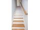 Staircase with light wood treads and a simple, modern handrail leading upstairs at 3541 Roswell Ne Rd # 20, Atlanta, GA 30305