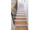 Modern staircase with wood steps and decorative black metal spindles at 3541 Roswell Ne Rd # 20, Atlanta, GA 30305