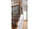 Elegant staircase with wood steps, white risers, and decorative black metal spindles at 3541 Roswell Ne Rd # 20, Atlanta, GA 30305