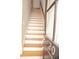 A view of the home's staircase featuring wood treads and a sleek handrail at 3541 Roswell Ne Rd # 20, Atlanta, GA 30305
