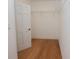 Walk-in closet featuring a wood floor, open white door, and wire shelving at 3541 Roswell Ne Rd # 20, Atlanta, GA 30305
