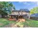Backyard with a covered porch, privacy fence, mature trees, and a grass lawn at 1464 Claredon Dr, Lawrenceville, GA 30043