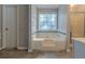 Bathroom features a large soaking tub with tile surround at 1464 Claredon Dr, Lawrenceville, GA 30043